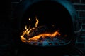 Glowing orange burning embers in a chiminea fire