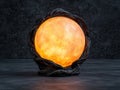 Glowing orb in dark, rustic setting