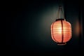 Glowing paper lantern against dark background Royalty Free Stock Photo