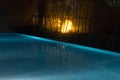 Glowing pool scene with creepy yellow lighting eminating onto th