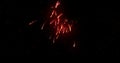 Glowing red firework exploding on black background with defocussed blue spots Royalty Free Stock Photo