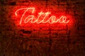 Glowing red neon signboard word tattoo Royalty Free Stock Photo