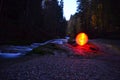 Glowing red orb beside water Royalty Free Stock Photo