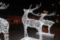 Glowing reindeer made of wire and light bulbs. Christmas decorations. Christmas Lights on reindeer shape wire frame mesh. Deer