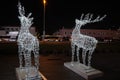 Glowing reindeer made of wire and light bulbs. Christmas decorations. Christmas Lights on reindeer shape wire frame mesh. Deer