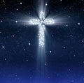 Glowing religious cross in stars