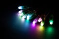 Glowing RGB led pixels christmas holiday lights on black background Royalty Free Stock Photo