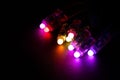 Glowing RGB led pixels christmas holiday lights on black background Royalty Free Stock Photo