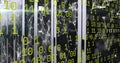 Glowing server cabinets displaying network graphic in data center room, with binary code overlay Royalty Free Stock Photo