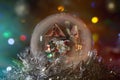 Glowing snow globe with Santa, house and lantern. Long exposure Royalty Free Stock Photo