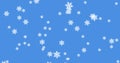 Glowing snow particles falling against blue background Royalty Free Stock Photo