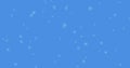 Glowing snow particles falling against blue background Royalty Free Stock Photo