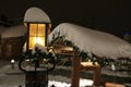 Glowing snowy lantern at night