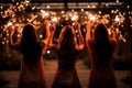 Glowing sparkles in hands group of happy people enjoying winter holiday party with fireworks