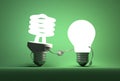 Glowing spiral light bulb character and tungsten one handshaking Royalty Free Stock Photo