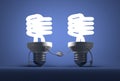 Glowing spiral light bulb characters handshaking Royalty Free Stock Photo