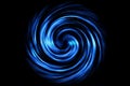 Glowing spiral tunnel with blue smoke on black background Royalty Free Stock Photo