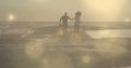 Glowing spots of light against african american couple holding hands running on the rocks