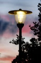 Glowing street lamp at dusk Royalty Free Stock Photo