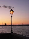 Glowing street lantern in the port, at sunset Royalty Free Stock Photo