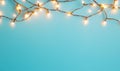 Glowing string lights on blue background, copy space for holiday design Royalty Free Stock Photo