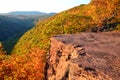 Glowing sunlight strikes a rock outcrop and fall foliage Royalty Free Stock Photo