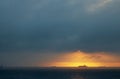 GLOWING SUNRISE ON THE INDIAN OCEAN WITH A SHIP ON THE HORIZON