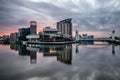 Dramatic cloudy skyline sunrise over Salford Quays, Media City near Manchester City Centre with stunning reflections.