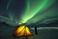 glowing tent under aurora borealis, person outside gazing up