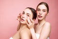 Glowing together. Unveiling natural beauty and hydration. Portrait of two young attractive girls applying under-eye
