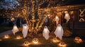 A glowing tree and spooky ghosts decorate a front yard for Halloween Royalty Free Stock Photo