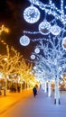Glowing trees adorned with lights create a magical atmosphere on a winter evening as people stroll by Royalty Free Stock Photo