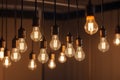 Glowing tungsten light bulbs with a warm golden light hanging from the ceiling