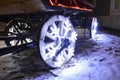 Glowing wheels, Christmas garland in the form of snowflakes on wooden cart wheels