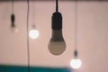 glowing light bulb against blue wall background Royalty Free Stock Photo