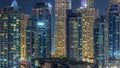 Glowing windows in multistory modern glass and metal residential buildings light up at night timelapse. Royalty Free Stock Photo