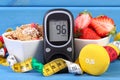 Glucometer for checking sugar level, healthy food, dumbbells and centimeter, diabetes, healthy and sporty lifestyle