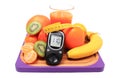 Glucometer, fresh fruits with tape measure and glass of juice Royalty Free Stock Photo