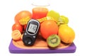 Glucometer, fruits, dumbbells, tape measure and glass of juice Royalty Free Stock Photo