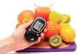 Glucometer, fruits, dumbbells, tape measure and glass of juice Royalty Free Stock Photo