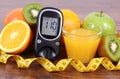 Glucometer, fruits, juice and tape measure, diabetes lifestyles and nutrition Royalty Free Stock Photo