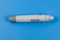 Glucometer isolated on a blue background. Medical device for measuring sugar