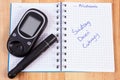 Glucometer with lancet device and polish inscription world diabetes day in notebook