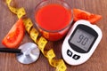 Glucometer for measuring sugar level with centimeter, fresh tomato and tomato juice, diabetes, healthy nutrition concept