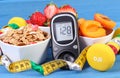 Glucose meter with result sugar level, healthy food, dumbbells and centimeter, diabetes, healthy and sporty lifestyle Royalty Free Stock Photo