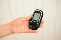 Glucometer with result of measurement sugar level and tape measure, concept of diabetes.