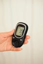 Glucometer with result of measurement sugar level and tape measure, concept of diabetes