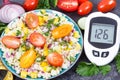 Glucometer with sugar level, salad with vegetables and bulgur groats, tape measure. Diabetes and healthy meal containing natural