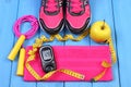 Glucometer, sport shoes, fresh apple and accessories for fitness on blue boards, copy space for text Royalty Free Stock Photo