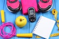 Glucometer, sport shoes, fresh apple and accessories for fitness on blue boards, copy space for text Royalty Free Stock Photo